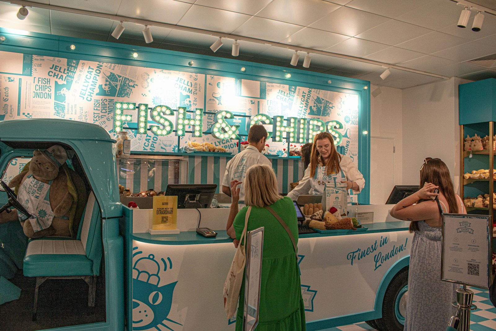 People ordering fish and chips at a counter